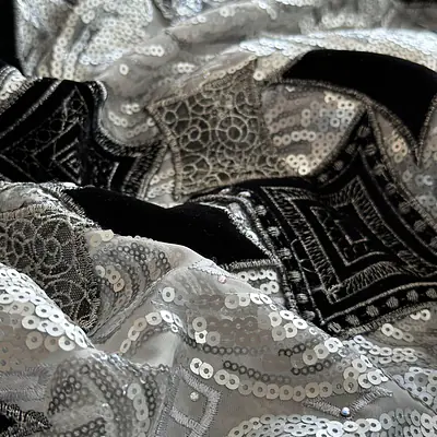 Silver sequins and black velvet patches on an organdy ground primary image